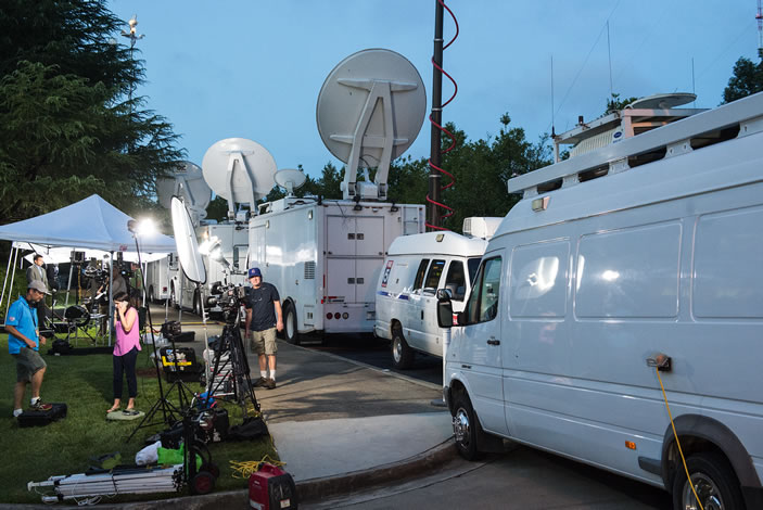 Media trucks lined up outside the Carter Center early Thursday morning to cover the live press conference.