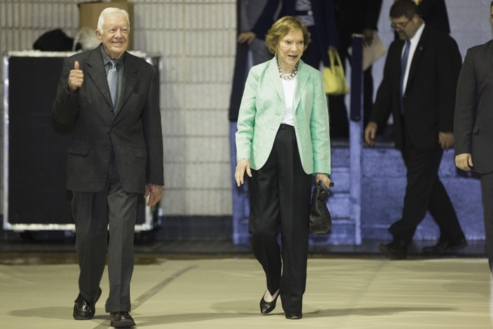 U.S. President Jimmy Carter gives a thumbs up as he enters the 35th Annual Carter Town Hall at Emory University