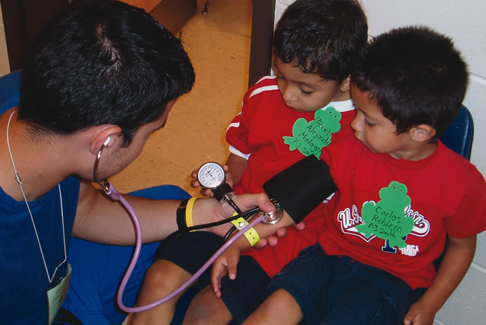 Nursing students conduct blood pressure screenings of children in Moultrie, Georgia