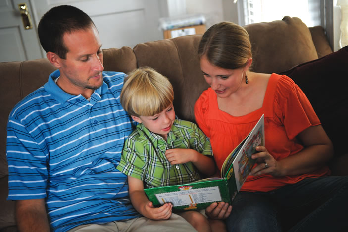 Ryan and Stephanie Harry reading to their son Christopher