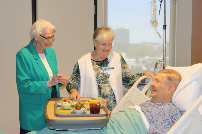 Sister Denis Marie Murphy and Sister Peggy Fannon visit with a patient on Saint Joseph¿s Day