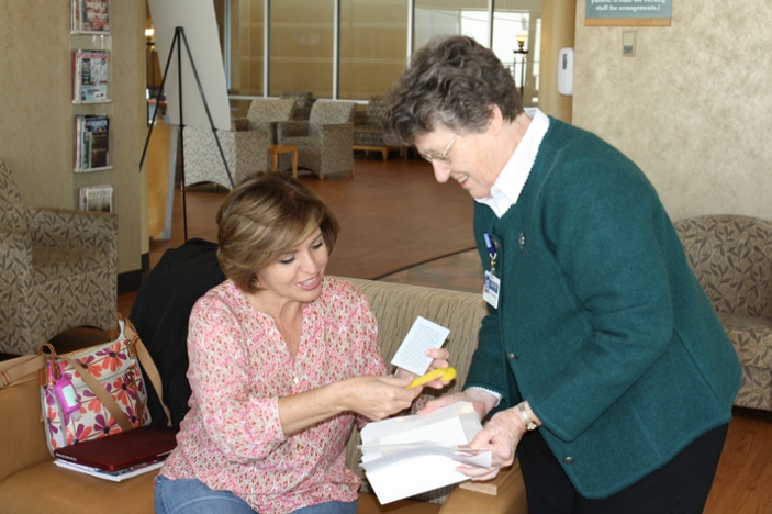 Sister Rosemary Smith distributes cards and cookies to visiting families on Saint Joseph¿s Day
