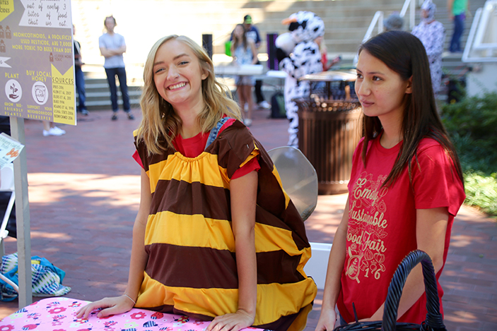 Students staffing honey booth at sustainable food fair