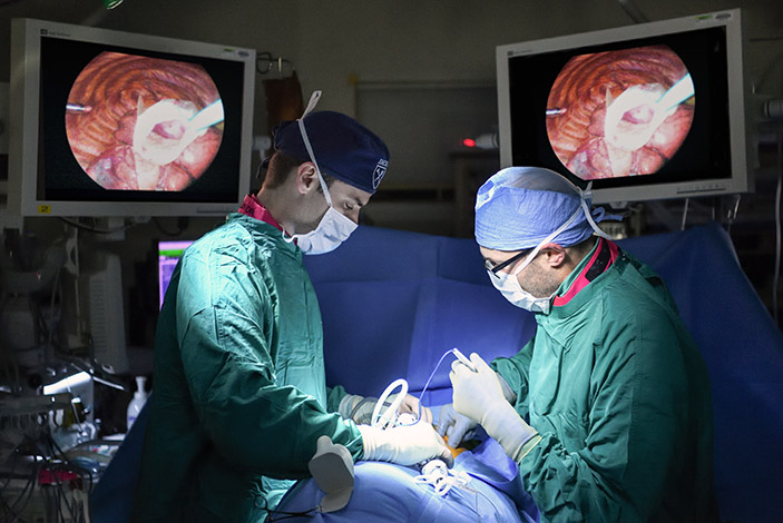 1 - Using minimally invasive surgery, Winship thoracic oncology surgeon Seth Force removes a nodule from patient Fred Erler's lung so it can be sent to the pathology lab, where a need biopsy can be performed.
