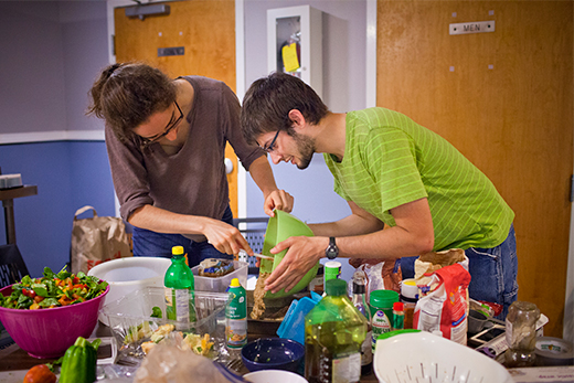 Scholarship and Service Summer Program participants Caroline Plott and Kevin Williams prepare a communal meal for the group. Emory Photo/Video