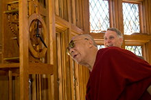 Dalai Lama examines clock with President Wagner