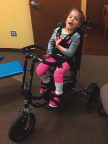 Jessie in her adaptive tricycle