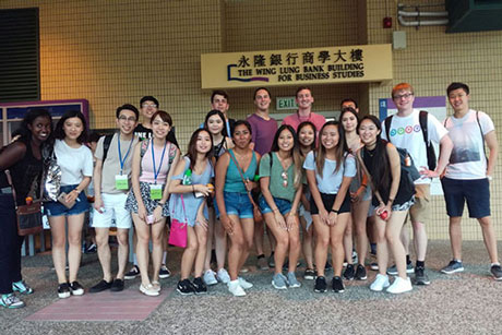 Four Emory undergraduates pose with their cohort of academic interns this summer in Hong Kong. 