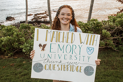 Newly admitted Emory students holds sign