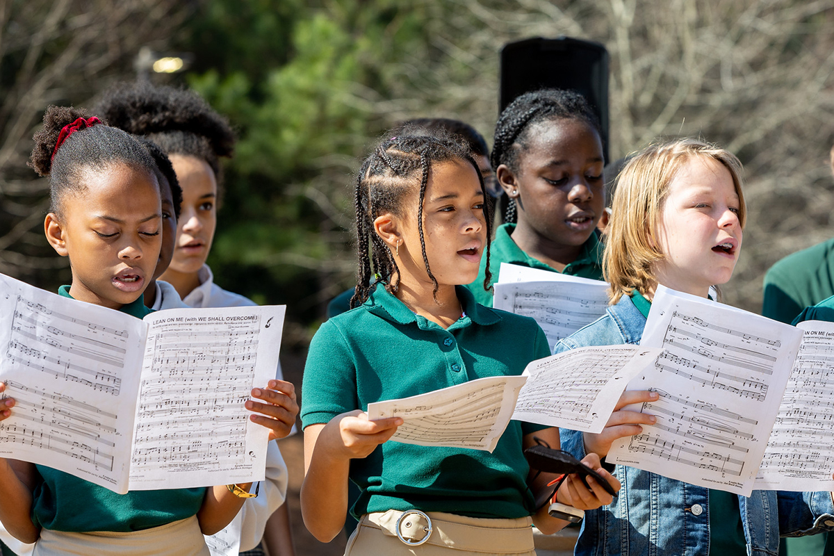 Young students give a musical performance outside of Drew Charter School