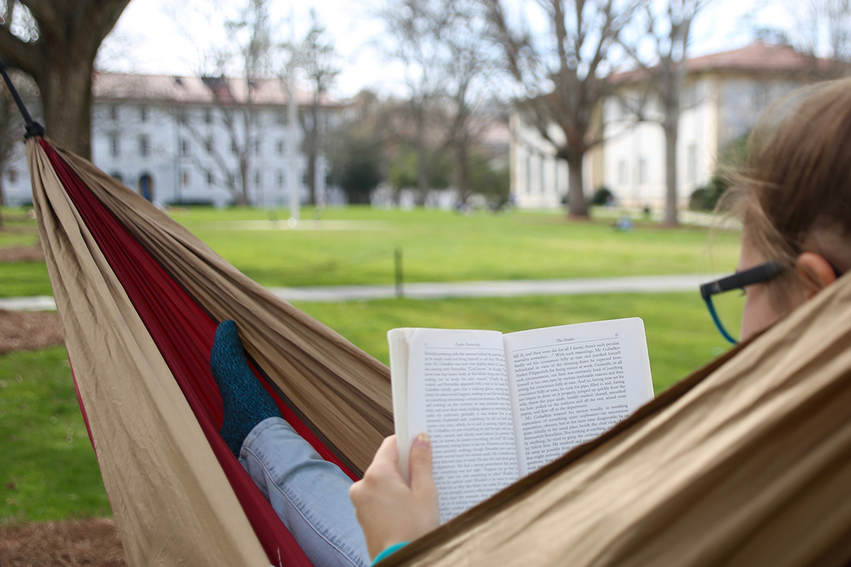 student reading while in hammock