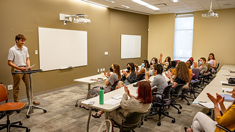 Students in a classroom giving presentations