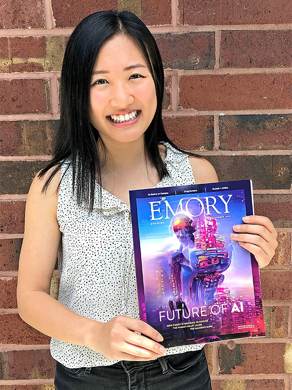 Student Sharon Lee holding Emory Magazine cover.