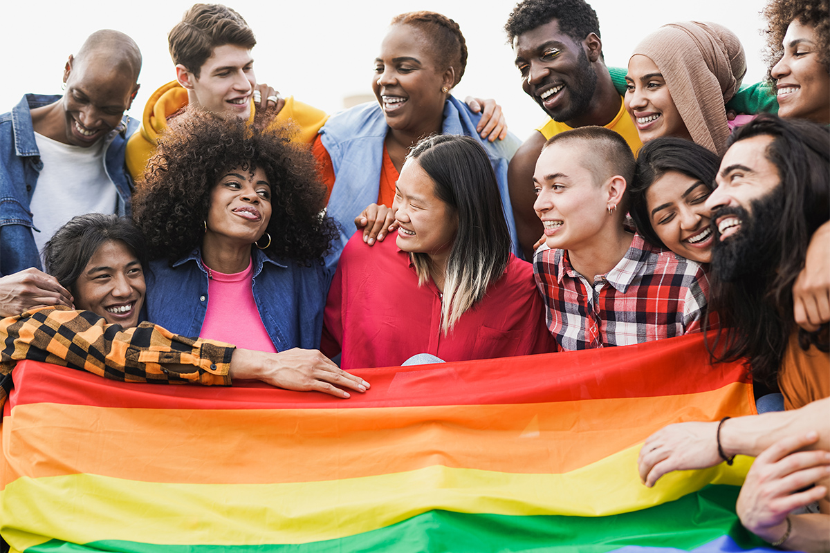 group of diverse college students holding a flag