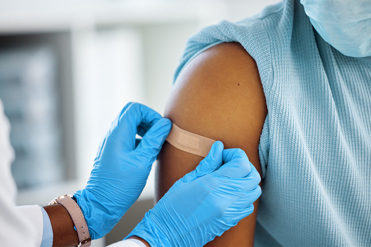 shoulder being bandaged after vaccine shot