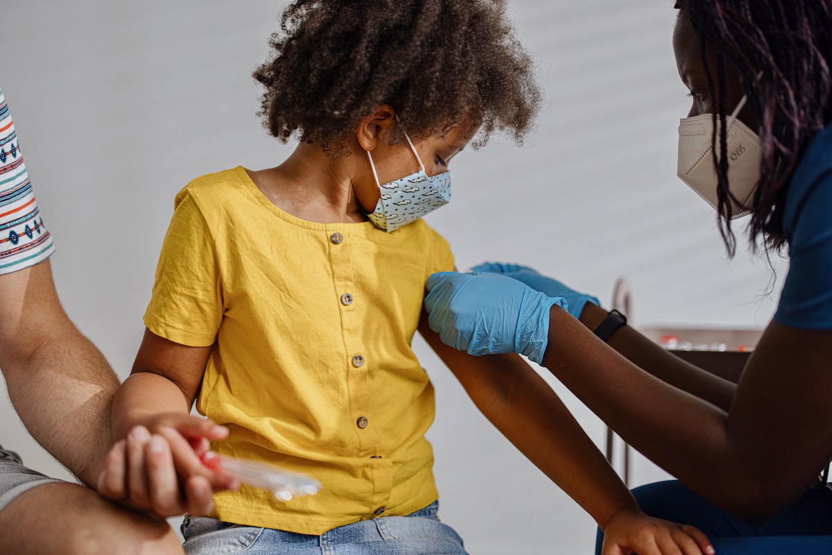 A child receives a vaccination from a provider