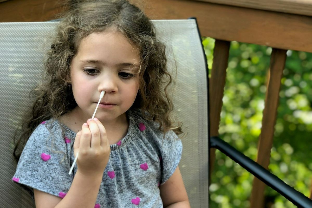 Image of a child taking a nasal sample
