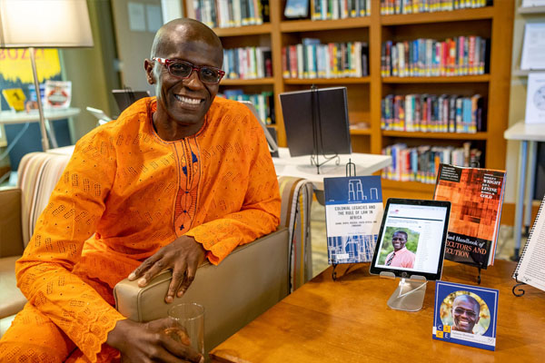Salmon Shomade poses with his published research.