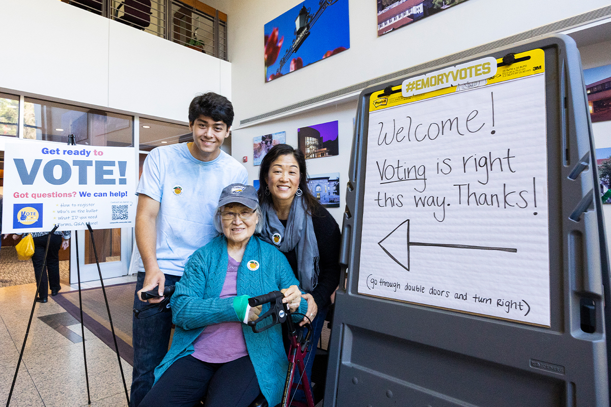 Grandmother with her daughter and grandson posing for photo outside Emory polling place