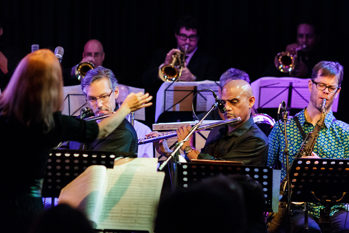 Conductor and six musicians performing