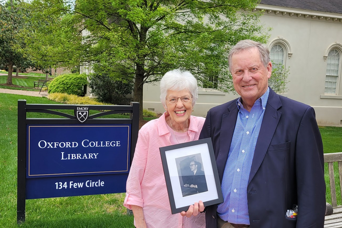 John F. Morgan holds a photo of Neil Shaw Penn and poses with Carol Penn