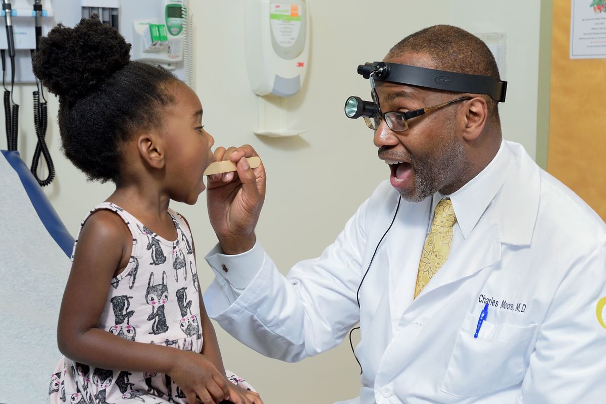 Georgia CTSA investigator examines a young patient.