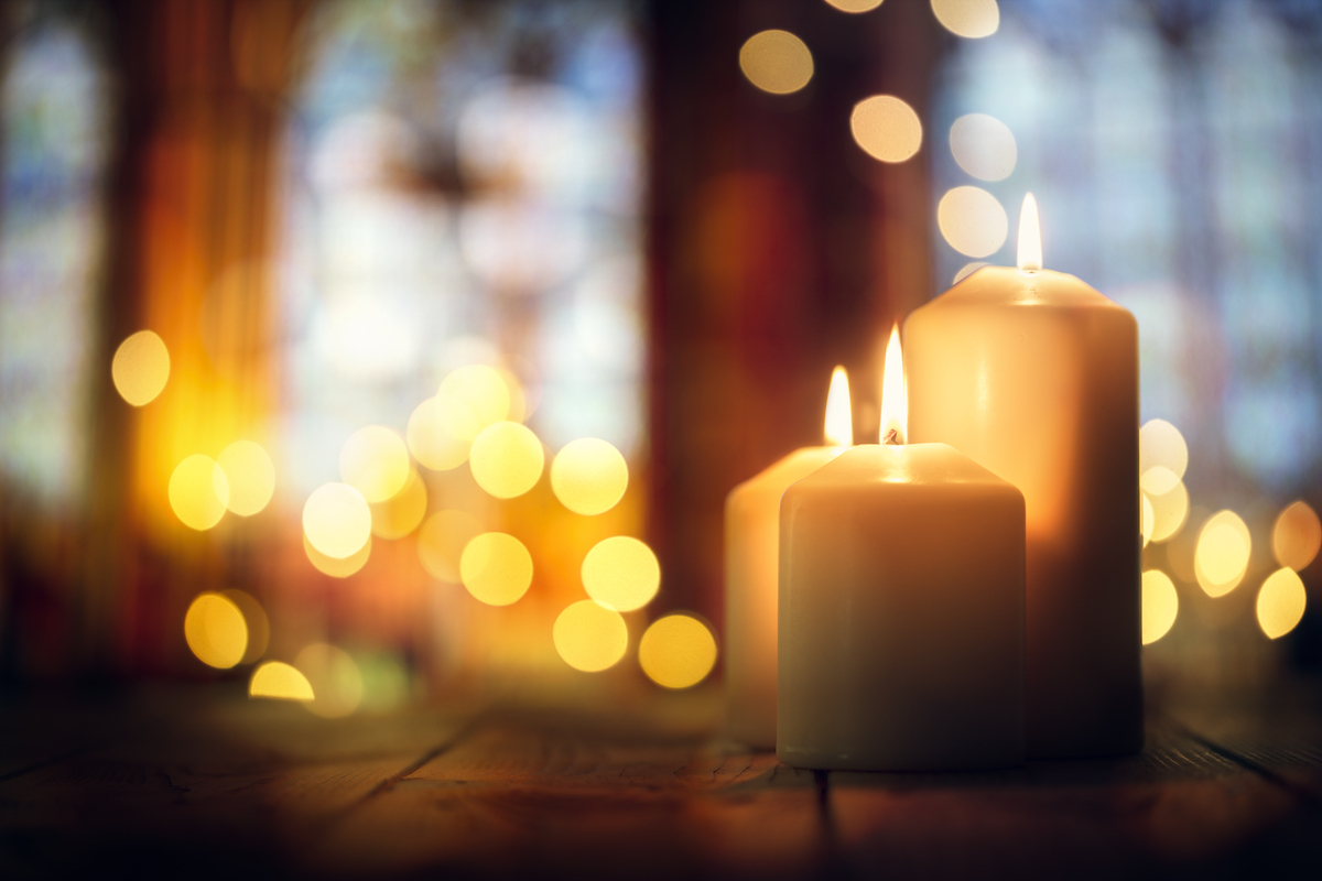 Photo: Soft focus of three burning candles with lense reflections 