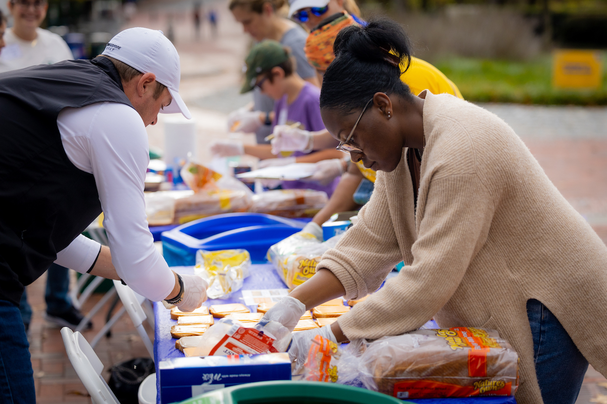 Photo: Students at a table preparing dozens of sandwiches