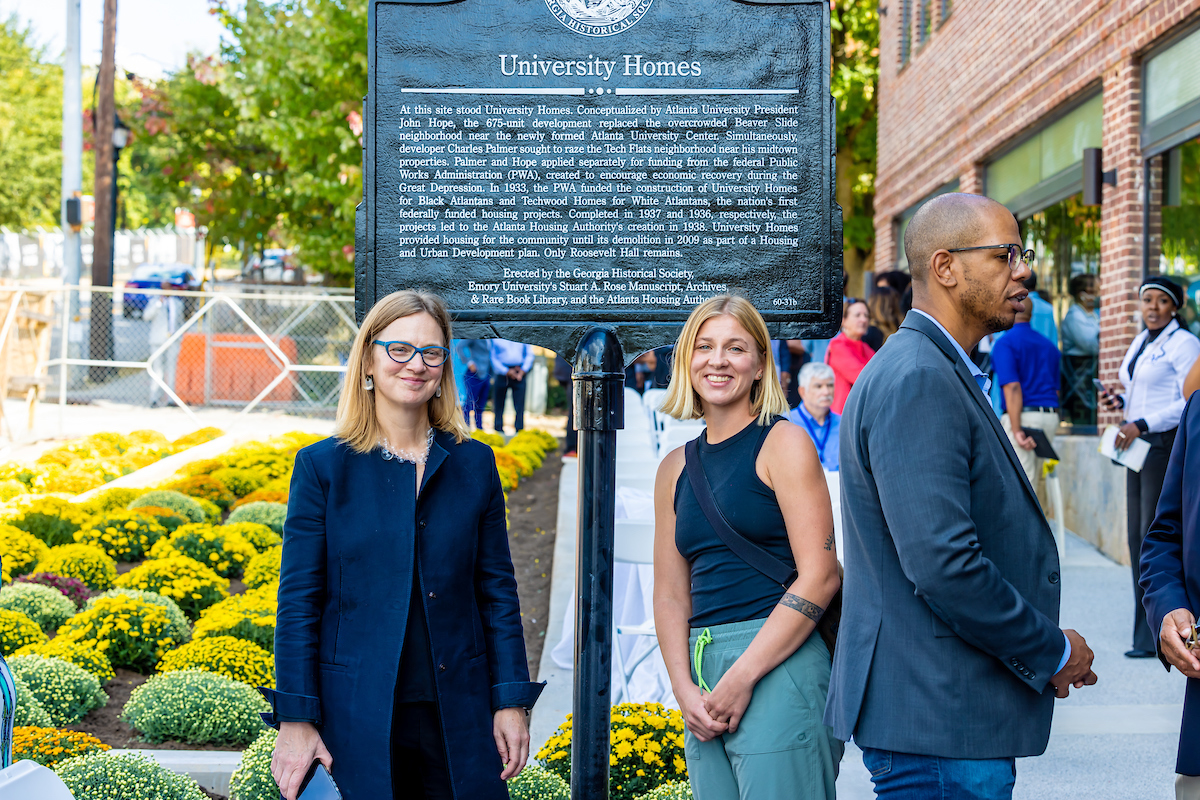 Photo: Crawford and graduate student Brooke Luokkala pose with historical marker between them 