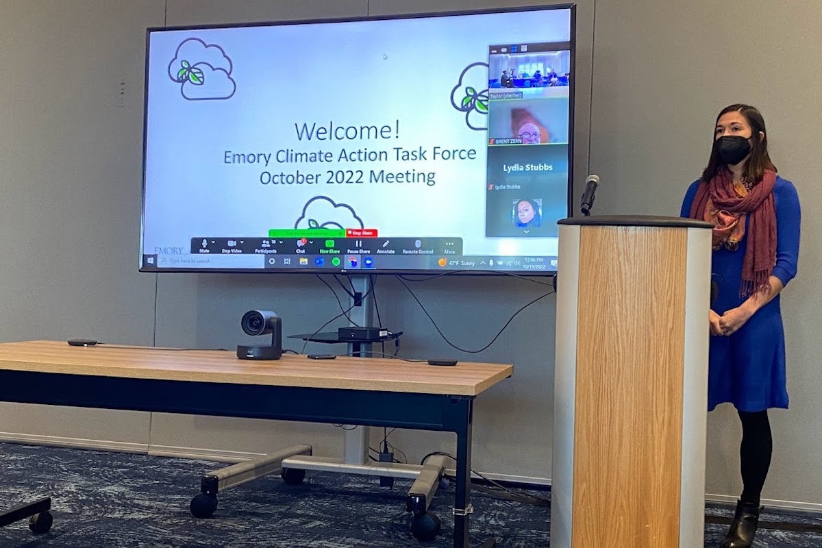 Photo: Student at lecturn with welcome message on screen 