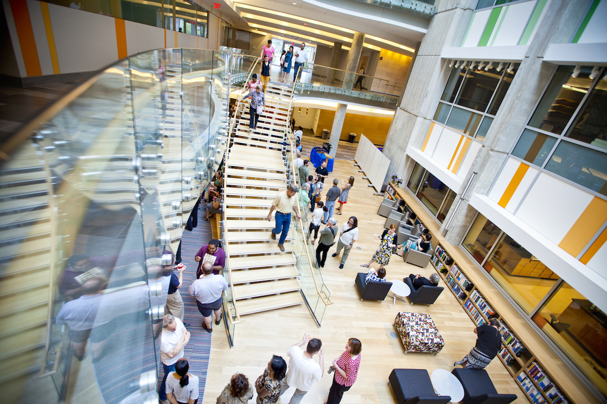 Photo: High-angle shot of students engaging and studying in common area of contemporary-design building