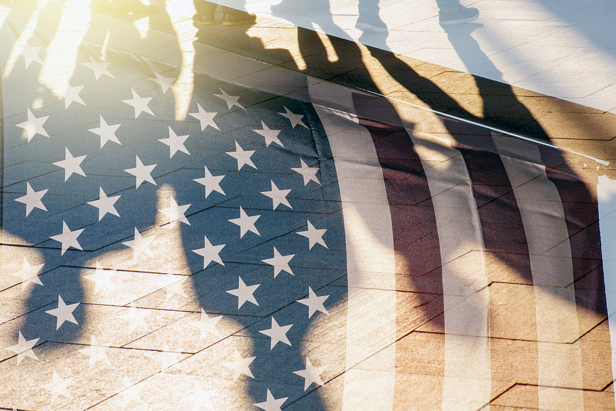 image of people's shadows over American flag