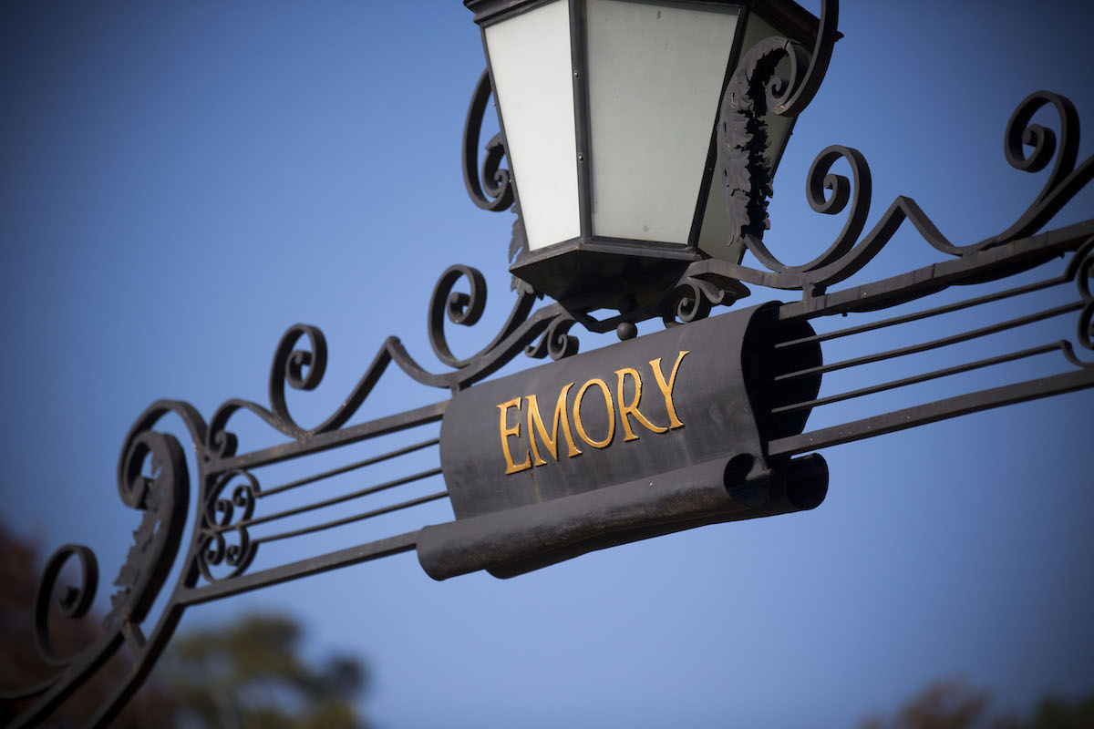 Photo: Close up of lantern and Emory name on ironwork over campus entry gate