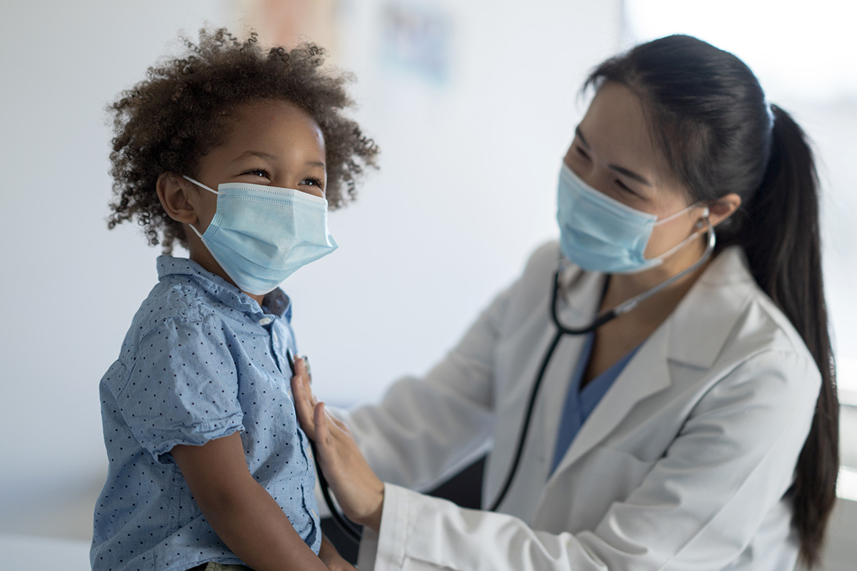 Stock image of pediatrician with child patient.