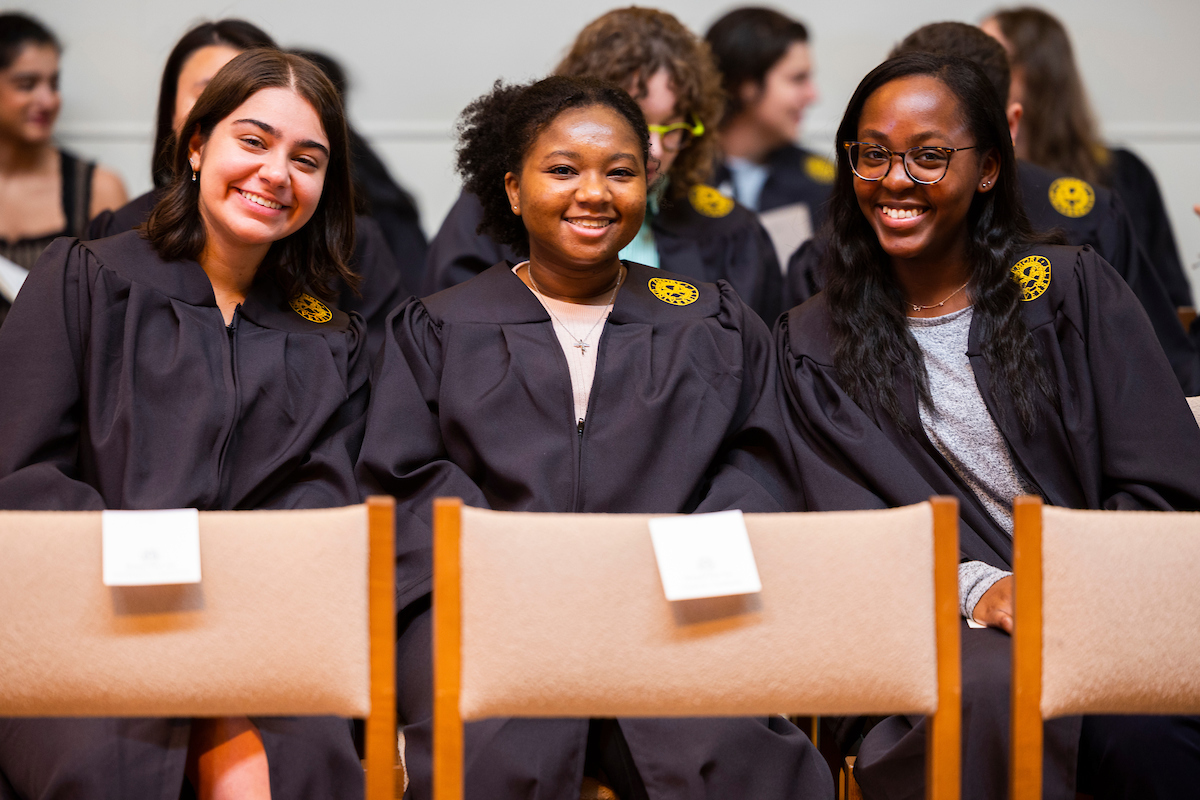 three students at graduation ceremony