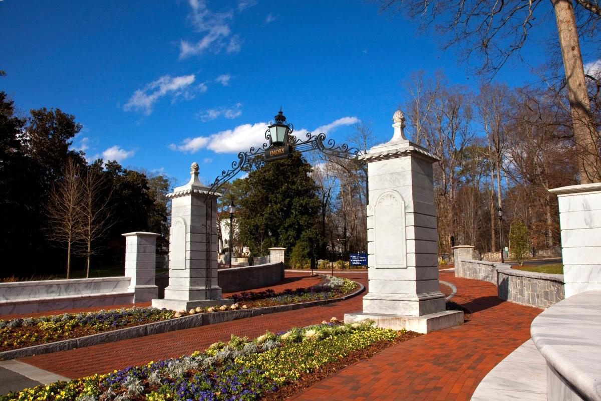 Emory University campus entry gate with spring flowers in front of it