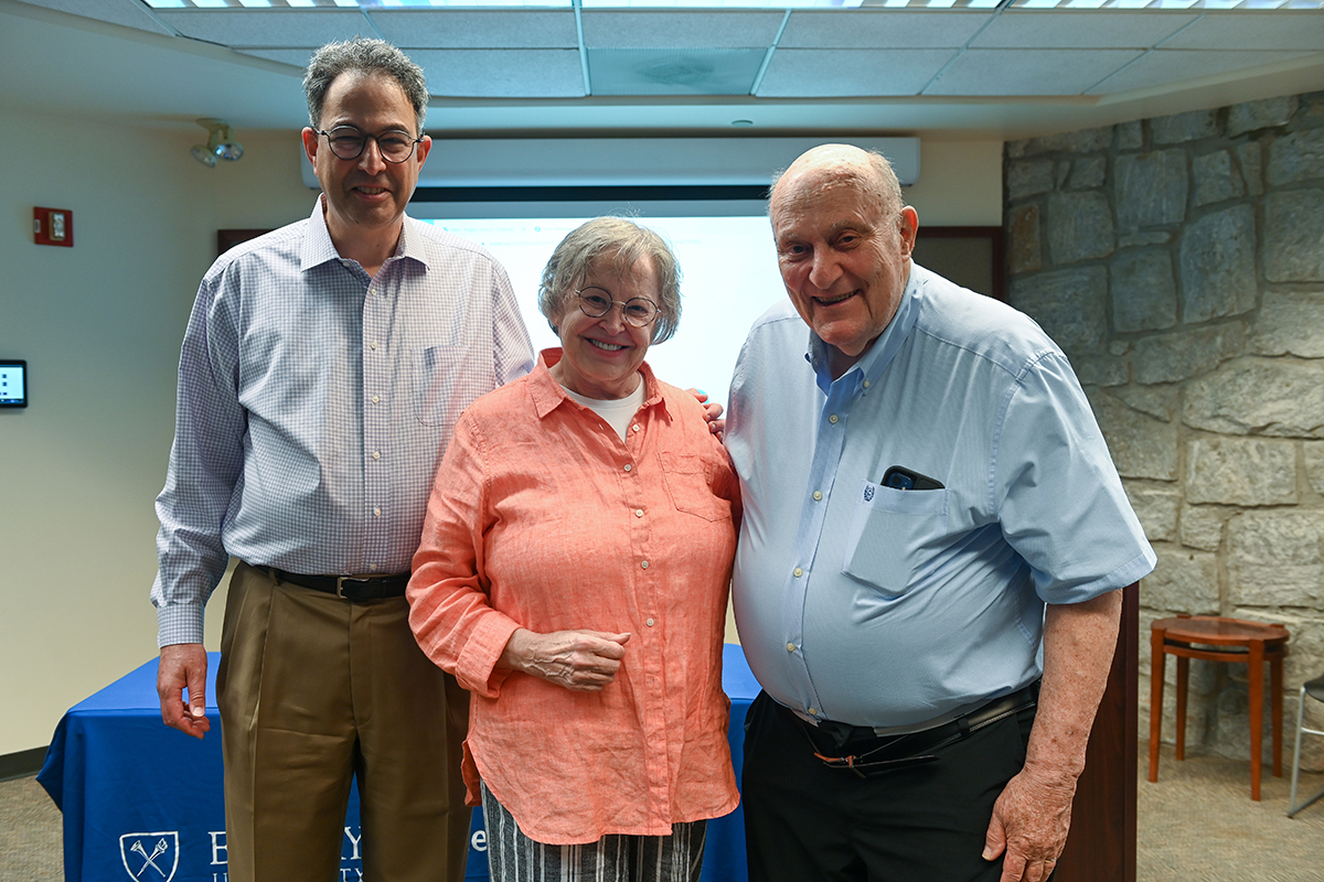 Three colleagues standing together, smiling