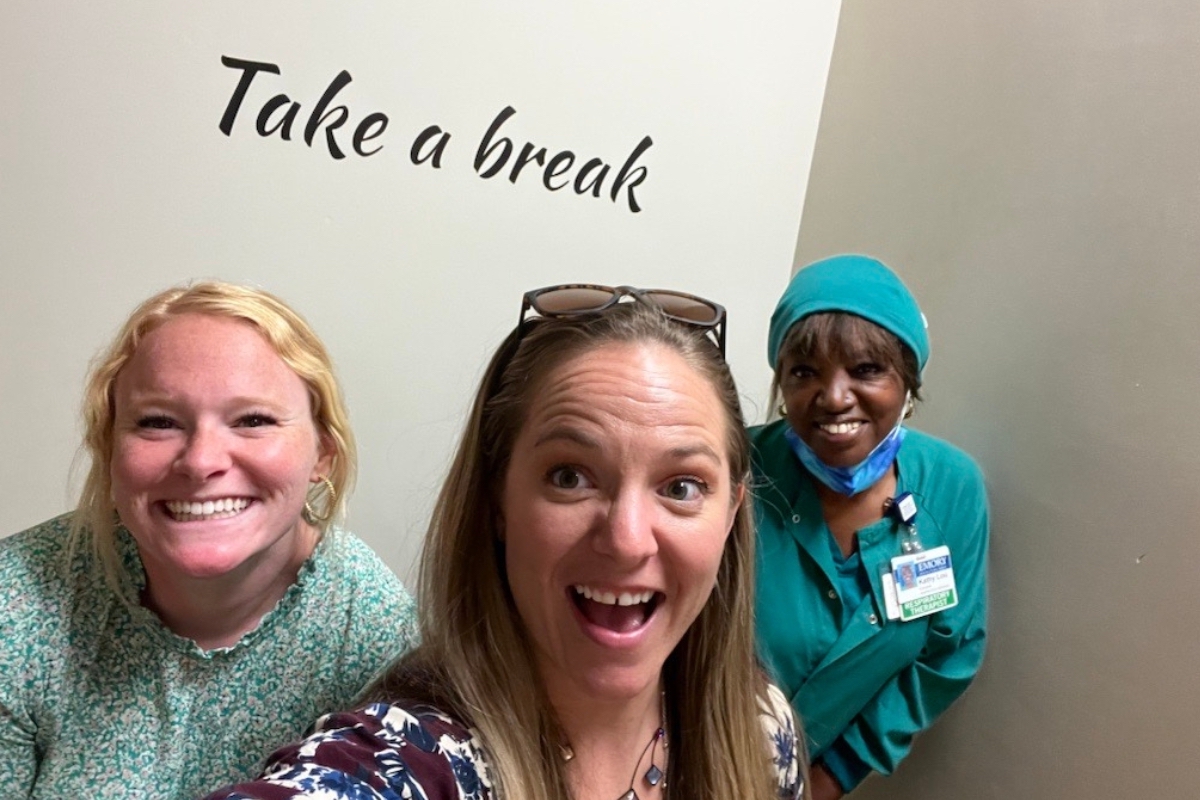 Women in stairwell with “take a break” lettering 