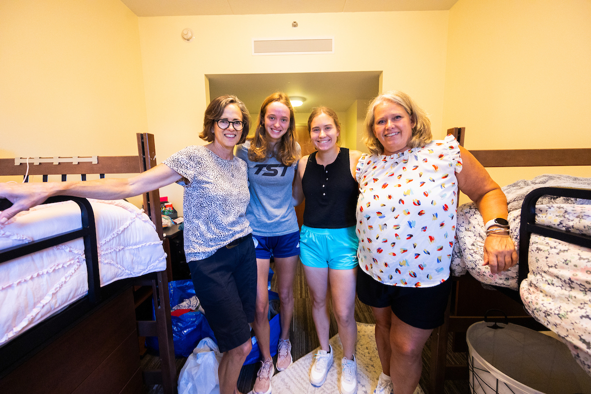 students and parents in dorm room