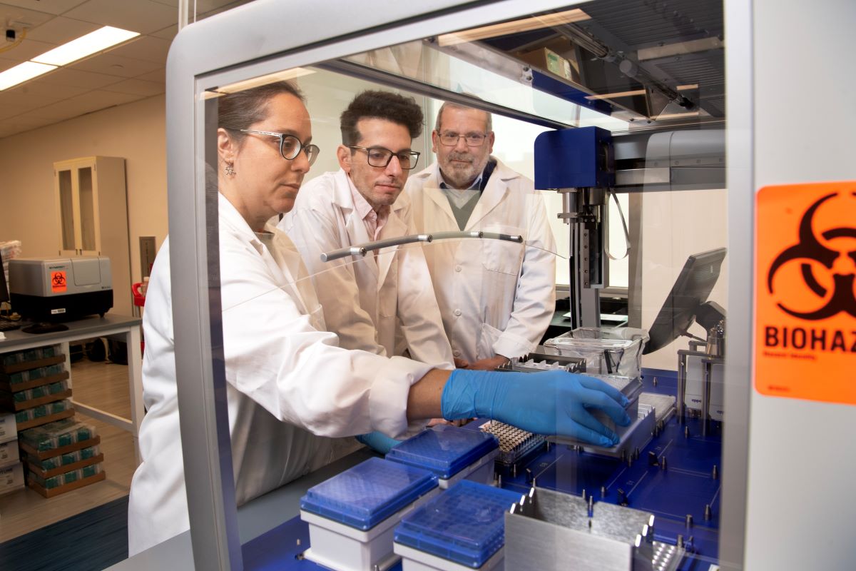 Scientists working on laboratory equipment