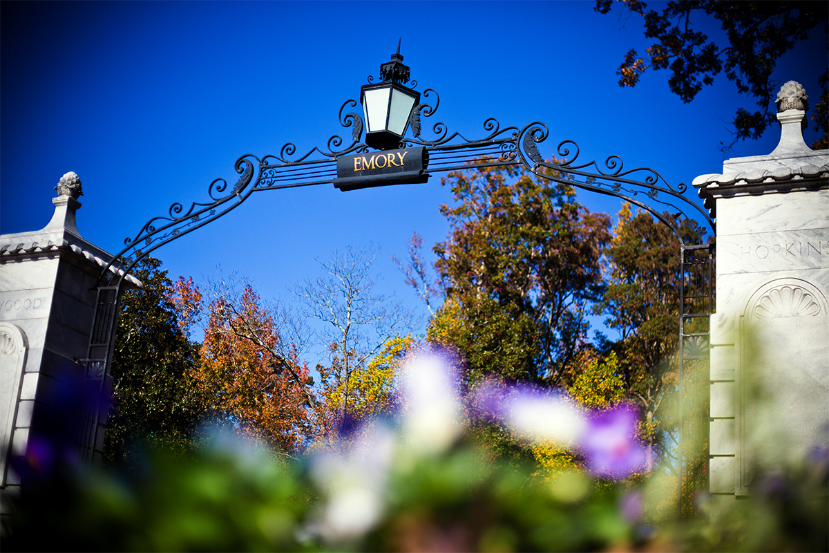 Emory University gate with purple flowers in foreground