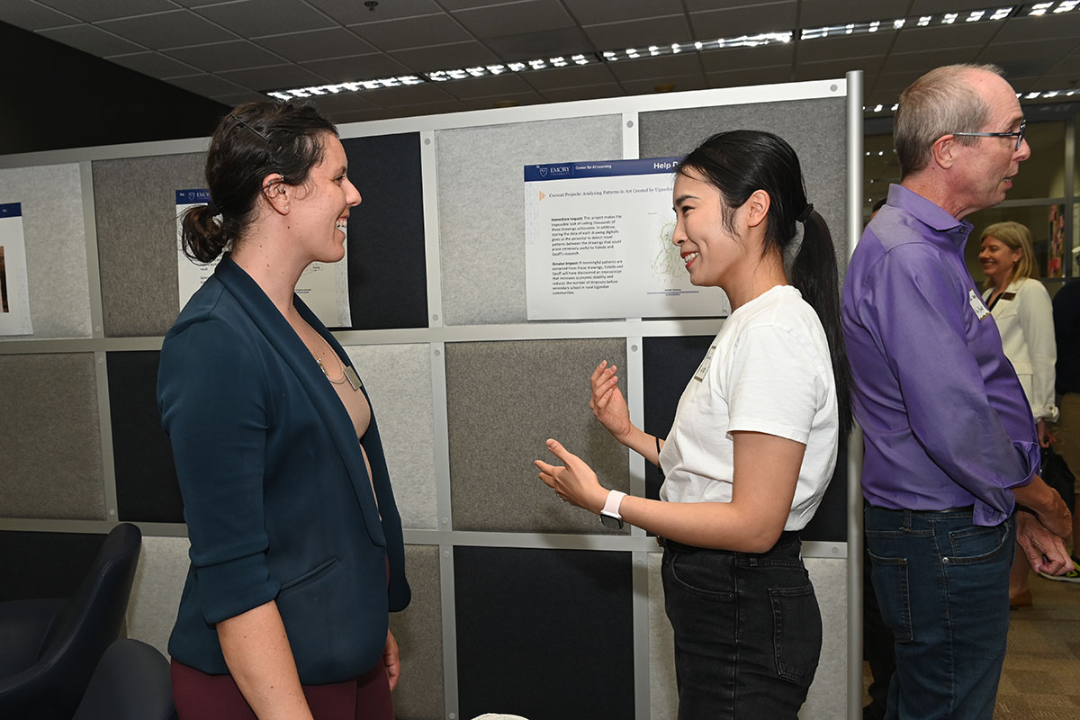 New AI.Humanity faculty members Julia Wrobel and Chang Su chat at the Center for AI Learning ribbon-cutting and open house event.