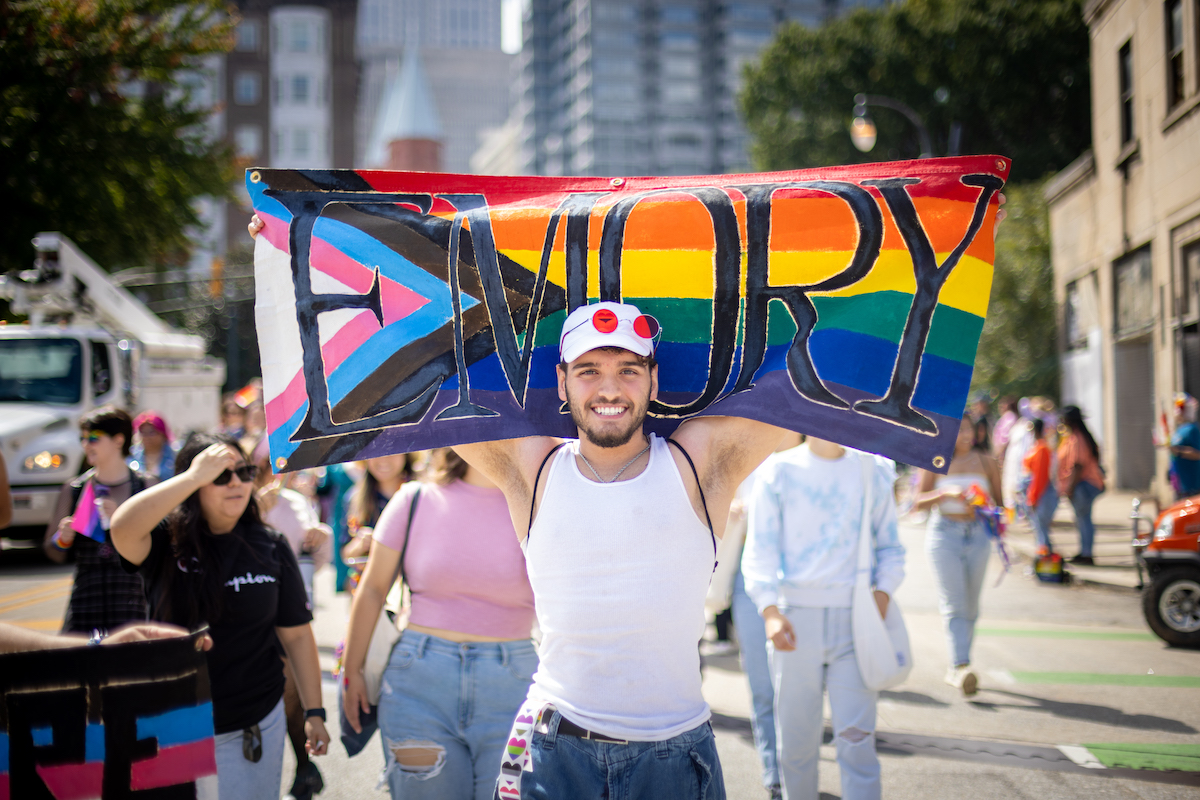 Emory student holding pride flag at parade