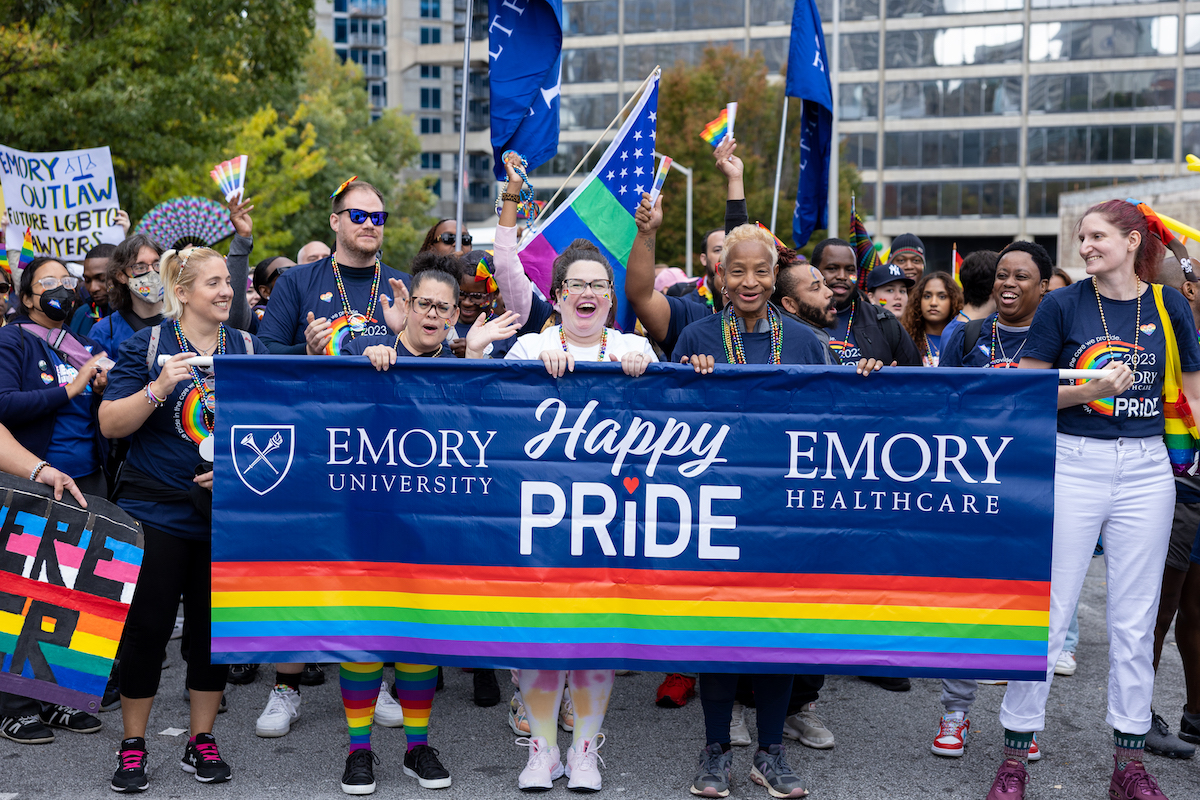 faculty with emory banner at pride