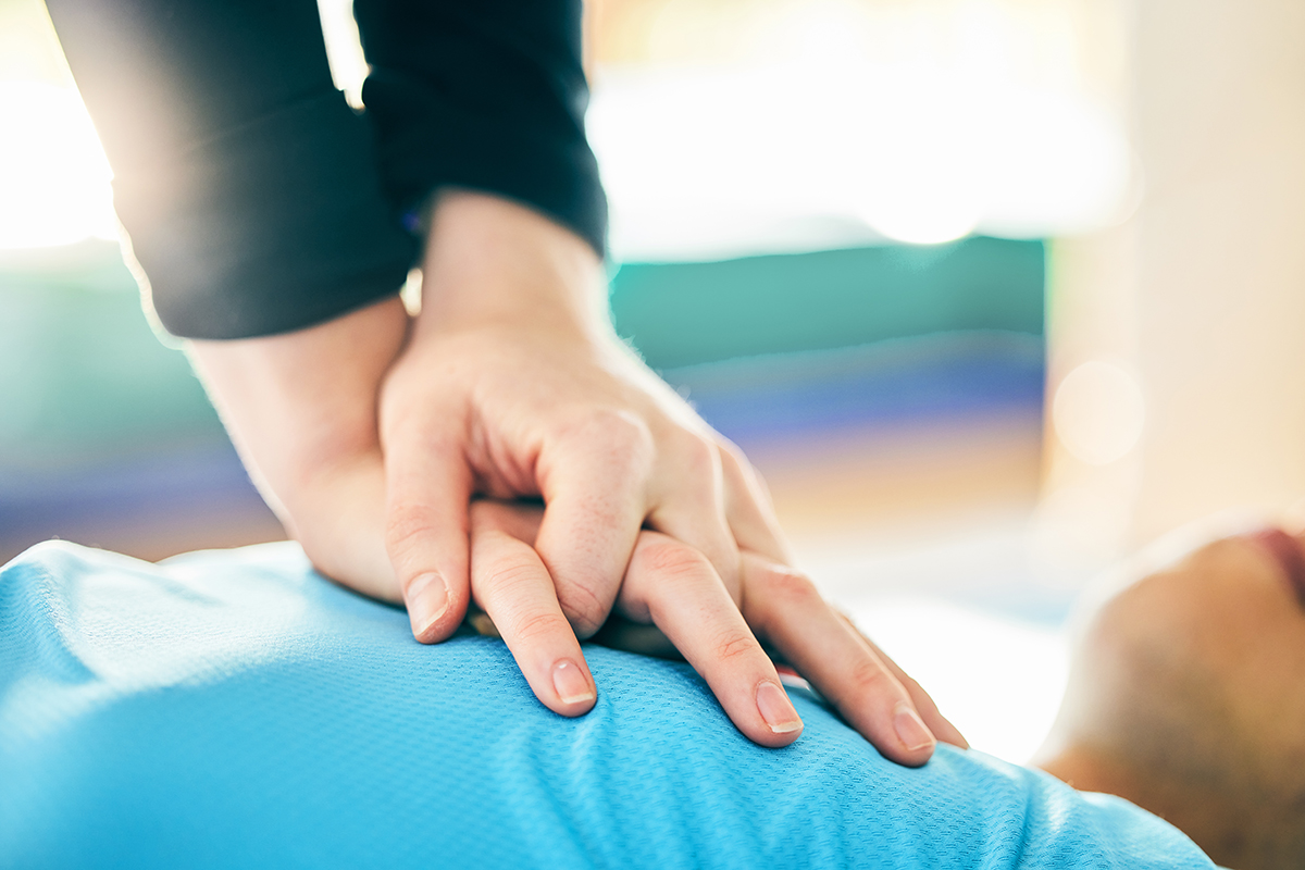 Woman gives CPR to man collapsed by bike.