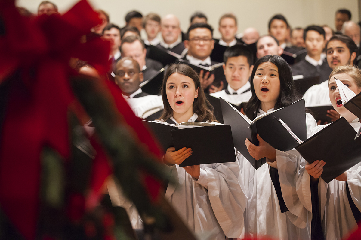Emory Choirs performing among Christmas trees