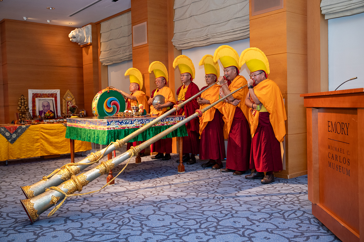 The monks play traditional instruments
