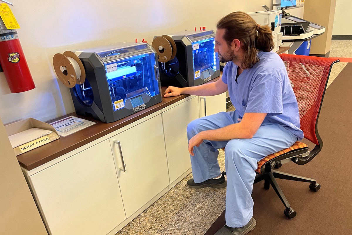 A student in the Woodruff Health Sciences Center Library uses one of the new 3-D printers.