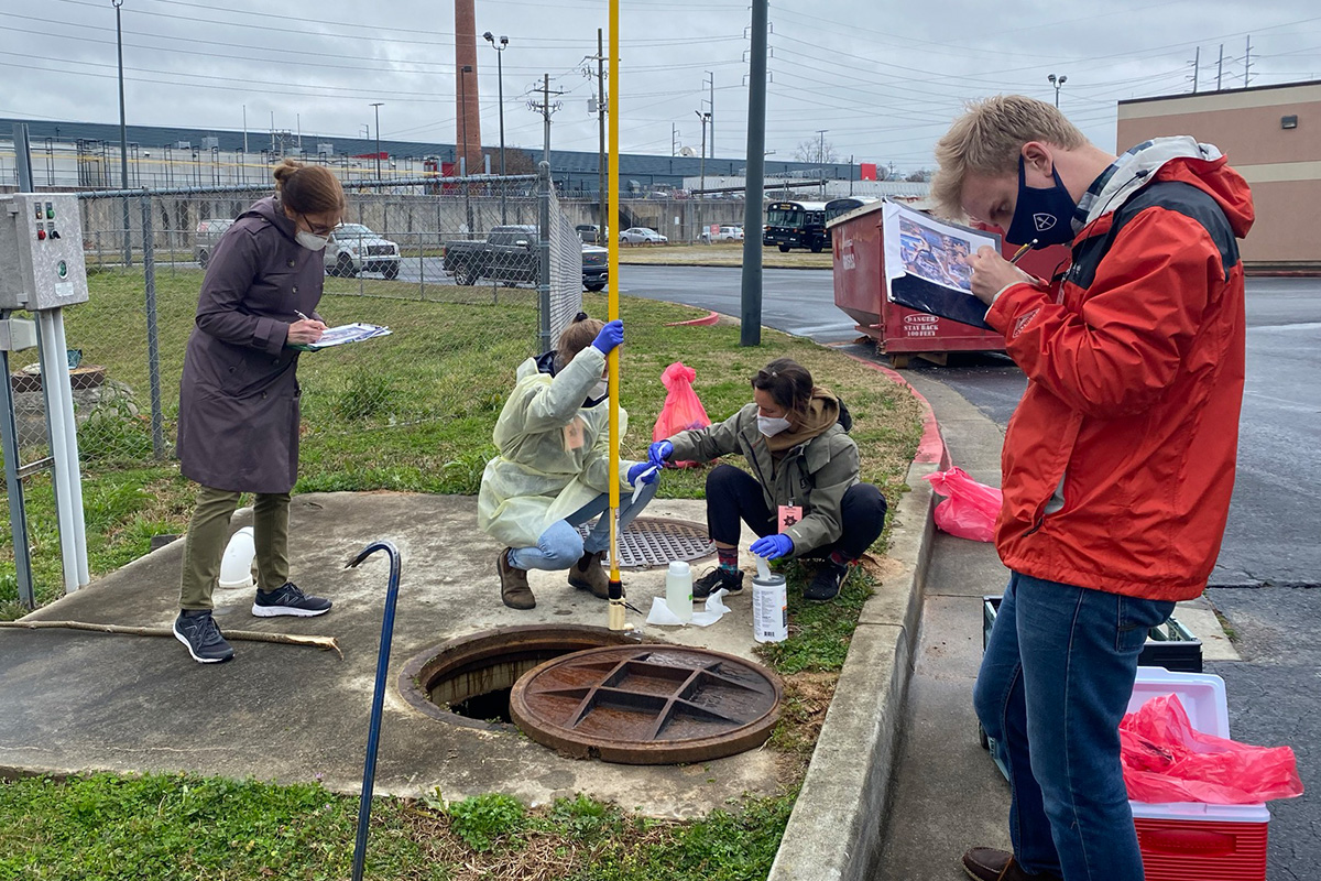 Emory researchers sampling wastewater outside of a prison