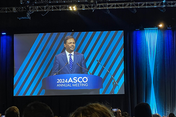 Suresh Ramalingam, MD, on giant screen during presentation at 2024 ASCO Annual Meeting.